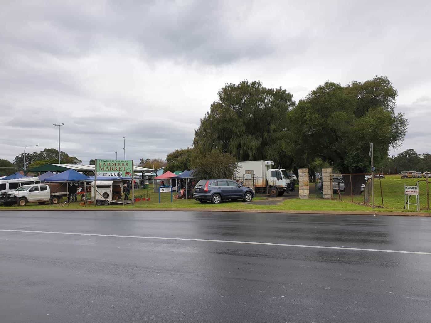 Stallholders under gazebos at the Boyanup Farmers Market in Western Australia