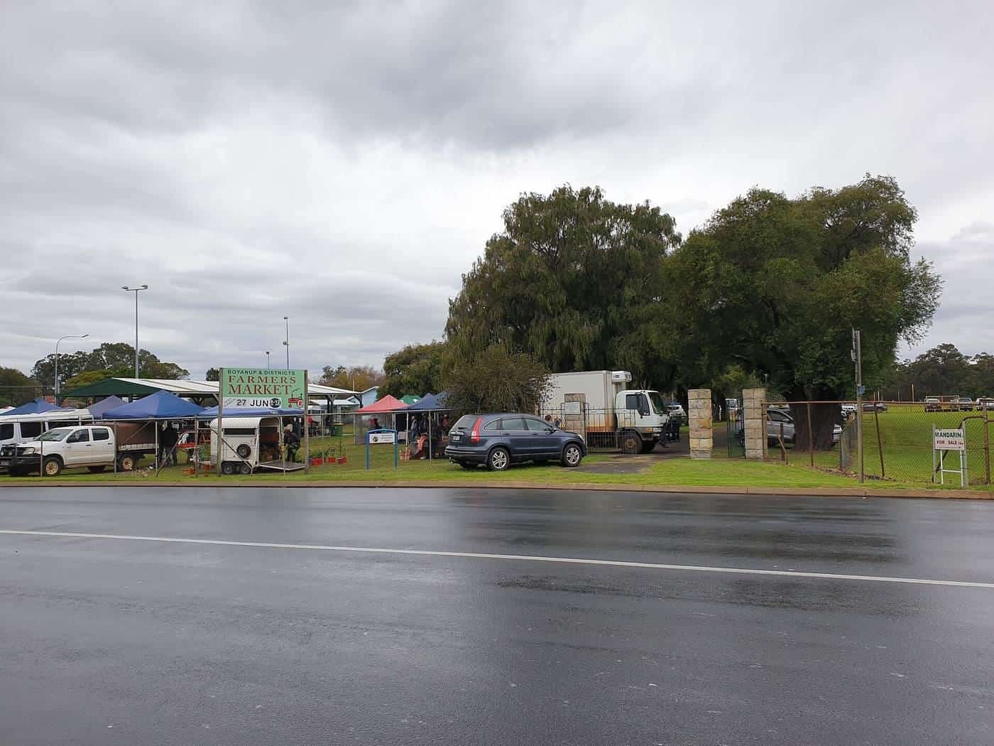Stallholders under gazebos at the Boyanup Farmers Market in Western Australia
