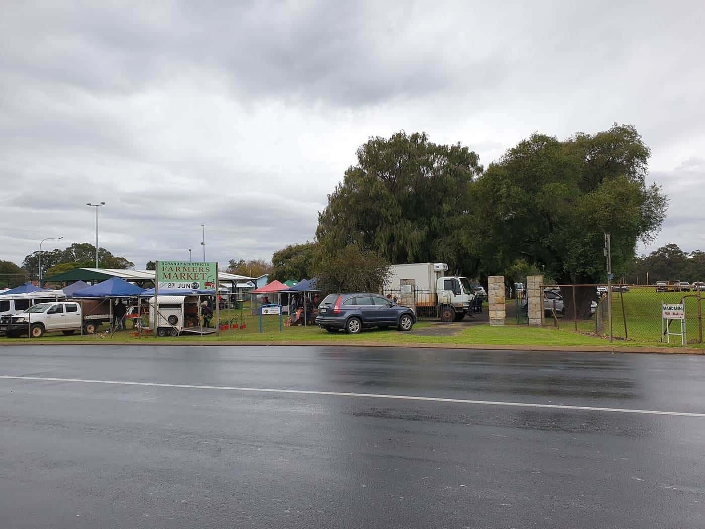 Stallholders under gazebos at the Boyanup Farmers Market in Western Australia
