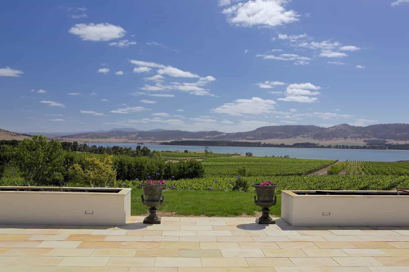 A garden path with urns leading to vineyards at Riversdale Estate, Tasmania