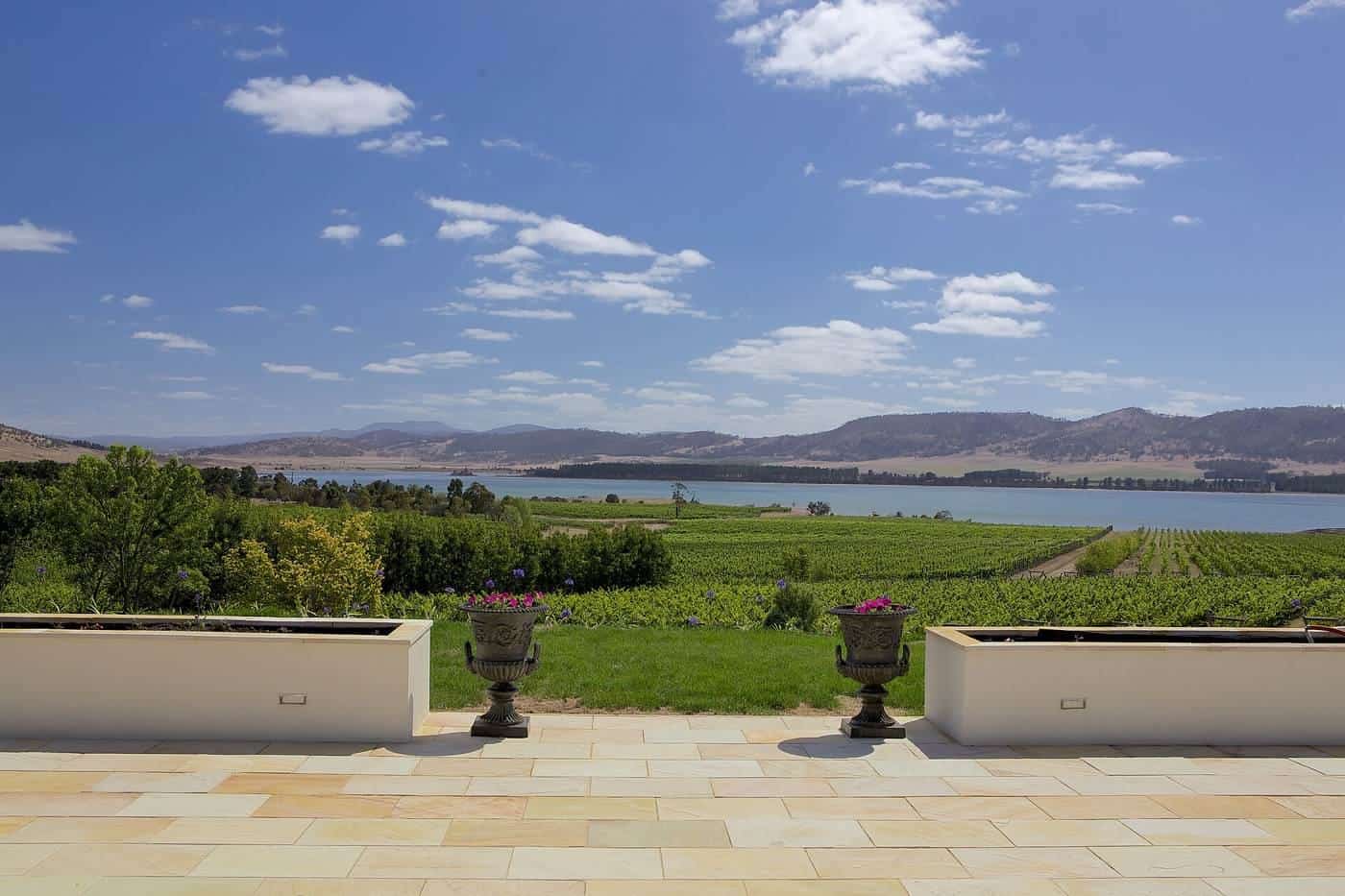 A garden path with urns leading to vineyards at Riversdale Estate, Tasmania