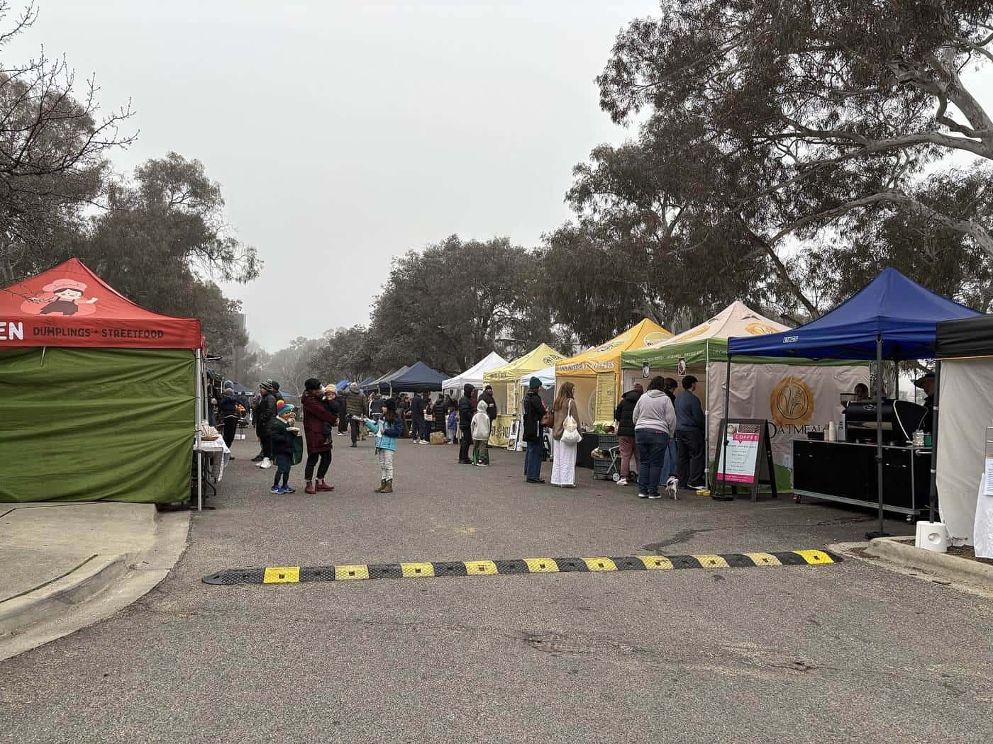 Rows of white pop-up gazebos at the Southside Farmers Market in Canberra